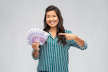 Image showing asian woman with money banknotes of thousands euro