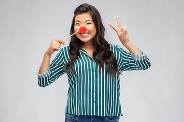 Image showing happy asian woman with red clown nose