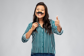 Image showing asian woman with vintage moustaches party prop