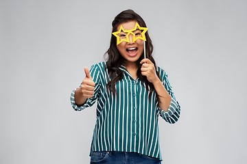 Image showing happy woman with party glasses showing thumbs up