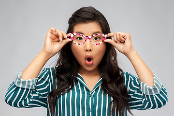 Image showing surprised asian woman with party glasses