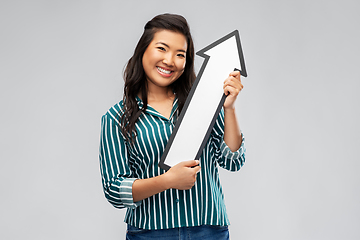 Image showing happy smiling asian woman with arrow pointing up