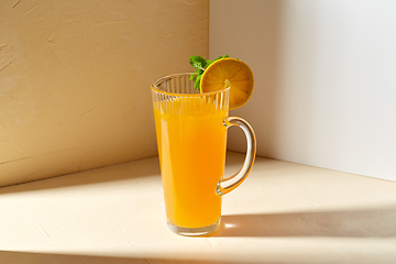 Image showing jug with orange juice and peppermint on table