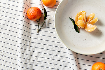 Image showing still life with mandarins on plate over drapery