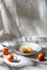 Image showing still life with mandarins on plate over drapery