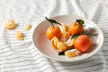 Image showing still life with mandarins on plate over drapery