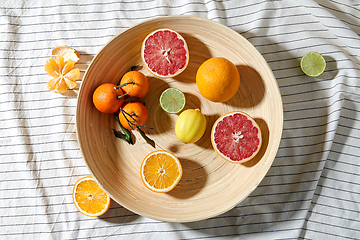 Image showing close up of citrus fruits on wooden plate