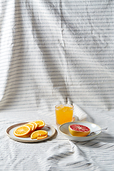 Image showing grapefruit, sliced orange and glass of juice