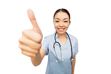 Image showing smiling asian female doctor showing thumbs up