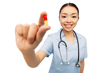 Image showing asian doctor with medicine and glass of water