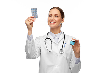 Image showing smiling female doctor holding medicine pills