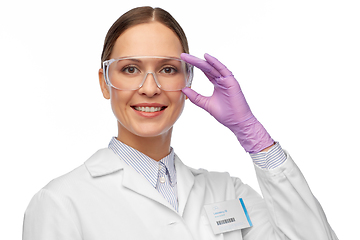 Image showing smiling female scientist in goggles and gloves