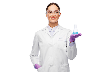 Image showing female scientist in goggles with chemical in flask