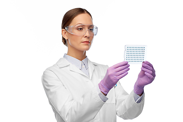 Image showing female scientist in goggles with chemical sample