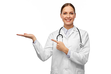 Image showing happy female doctor holding something on her hand