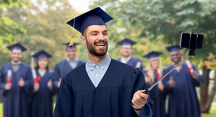 Image showing male graduate student with smartphone takes selfie