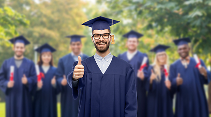 Image showing happy male graduate student showing thumbs up