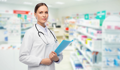 Image showing doctor with folder and stethoscope at pharmacy