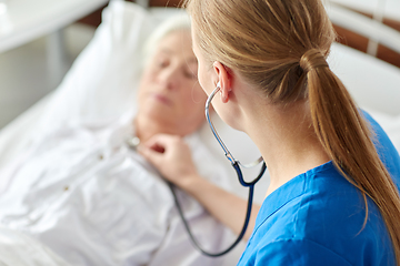 Image showing doctor with stethoscope and old woman at hospital