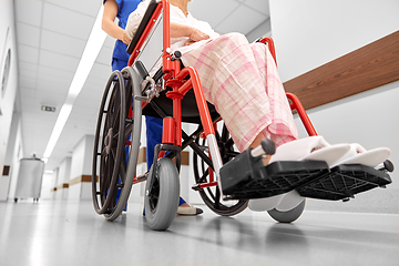 Image showing nurse with senior patient in wheelchair at clinic