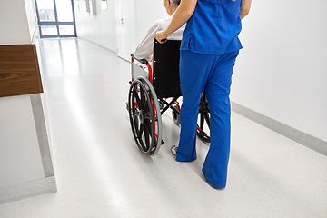 Image showing nurse with senior patient in wheelchair at clinic