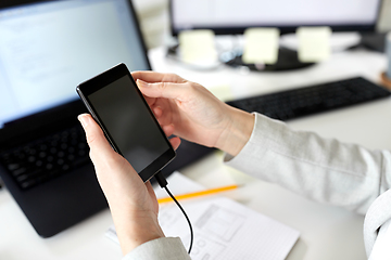 Image showing businesswoman with smartphone working at office