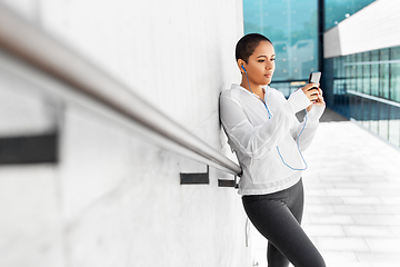 Image showing african american woman with earphones and phone