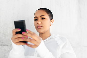 Image showing african american woman with earphones and phone