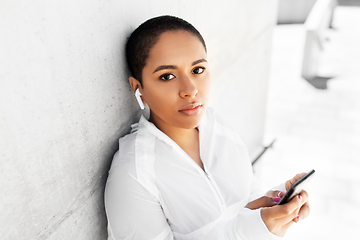 Image showing african american woman with earphones and phone