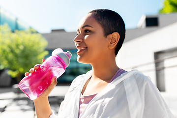 Image showing african american woman drinking water from bottle