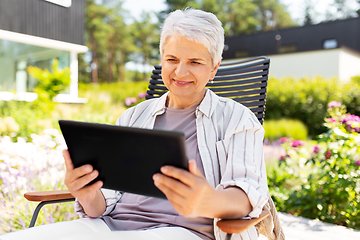 Image showing happy senior woman with tablet pc at summer garden