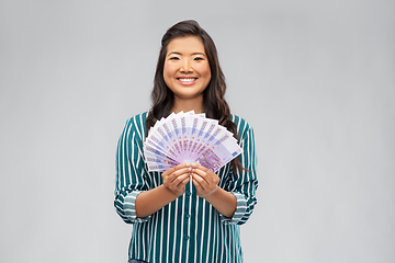 Image showing asian woman with money banknotes of thousands euro