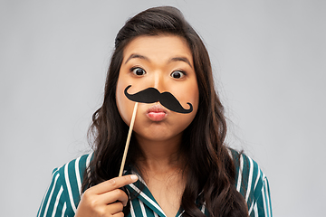 Image showing asian woman with vintage moustaches party prop