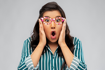 Image showing surprised asian woman with party glasses