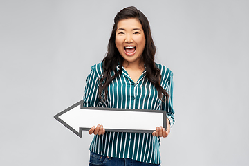 Image showing happy smiling asian woman with leftward arrow