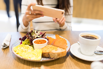 Image showing Woman taking photo on her meal