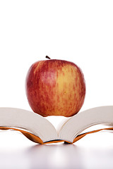 Image showing apple over a open book 