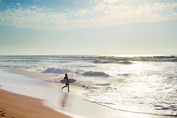 Image showing Surfer running to surf