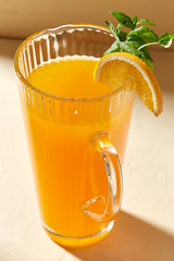 Image showing jug with orange juice and peppermint on table