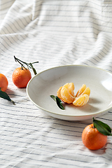 Image showing still life with mandarins on plate over drapery