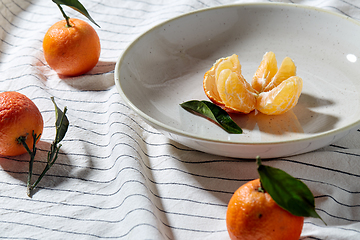 Image showing still life with mandarins on plate over drapery