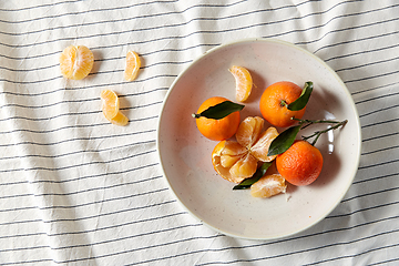 Image showing still life with mandarins on plate over drapery