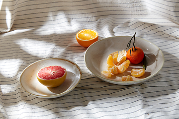 Image showing still life with mandarins and grapefruit on plate