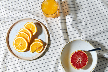 Image showing grapefruit, sliced orange and glass of juice