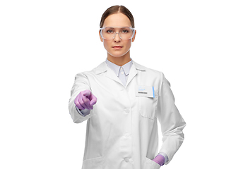 Image showing female scientist in goggles pointing to camera