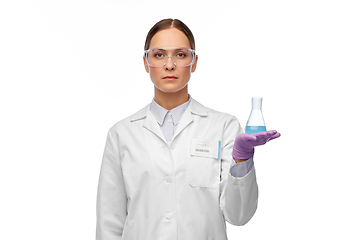 Image showing female scientist in goggles with chemical in flask