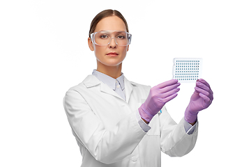 Image showing female scientist in goggles with chemical sample