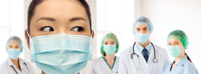 Image showing close up of asian doctor in mask at hospital