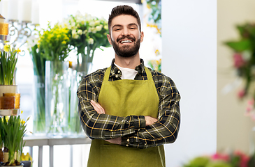 Image showing happy young male seller in apron at flower shop