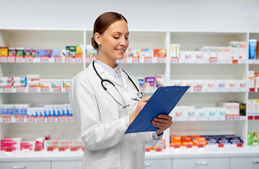 Image showing happy smiling female doctor with clipboard